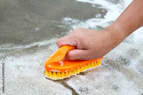 Hand wash carpet with a brush. Washing the carpet. Close-up. Background. Texture.