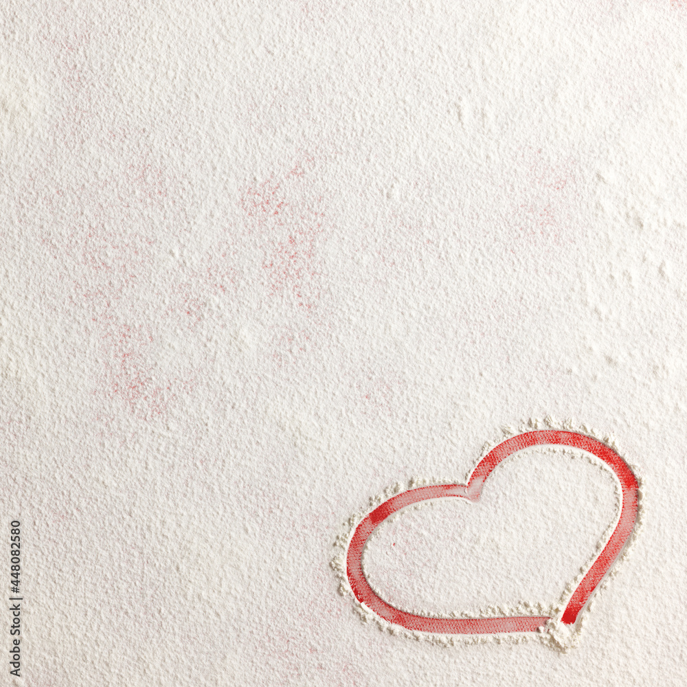 Valentine love red heart shape made of flour on red background. Closeup.Christmas card.