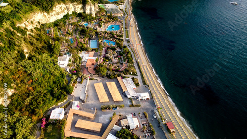 Overhead aerial view of Ischia Citara Beach at sunset with sand. photo