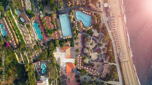 Overhead aerial view of Ischia Citara Beach at sunset with pools and sand.