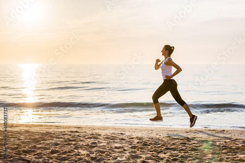 Beautiful woman running by the sea