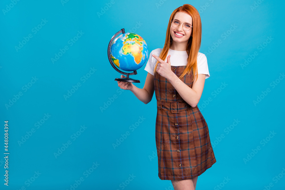 Fototapeta premium Portrait of attractive cheerful girl holding globe demonstrating country trip climate isolated over bright blue color background