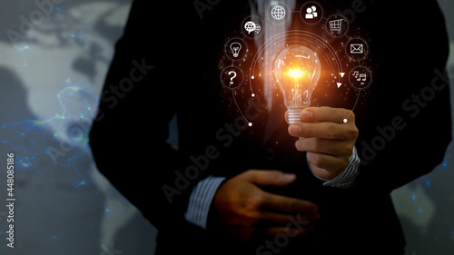 Businessman hand holding light bulb,Business global internet connection application technology and digital marketing, Financial and banking Digital link tech marketing network big data.