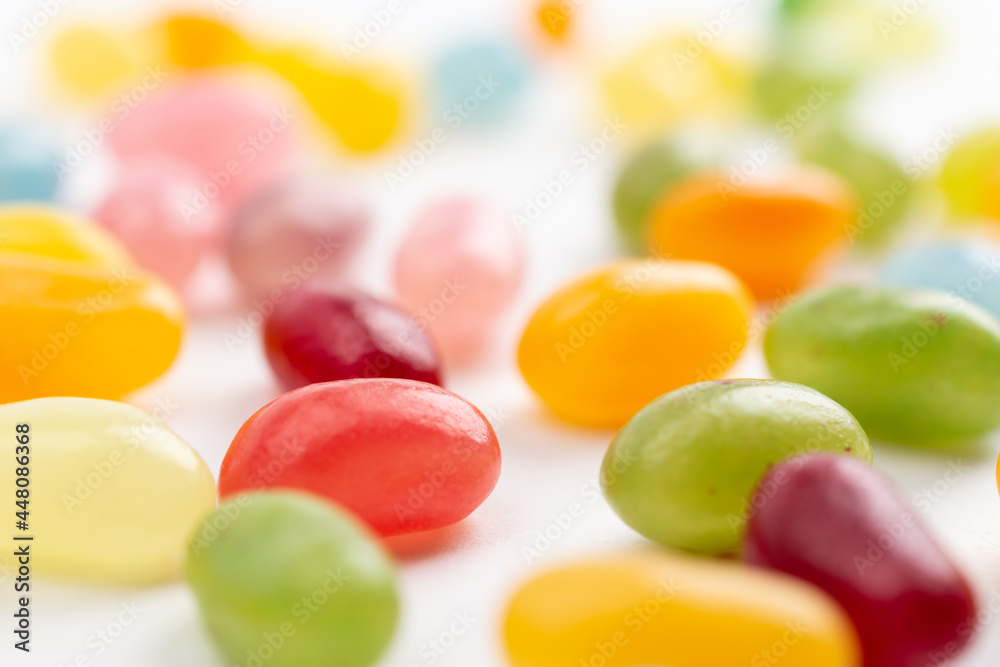 Closeup of jelly beans scattered on white background Closeup of jelly beans scattered on white background