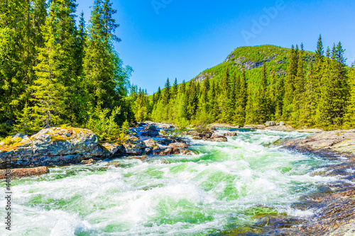 Fast flowing river water of beautiful waterfall Rjukandefossen Hemsedal Norway. photo