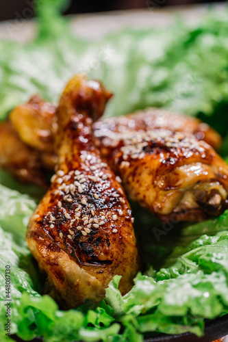 Roasted chicken thighs on a green salad 