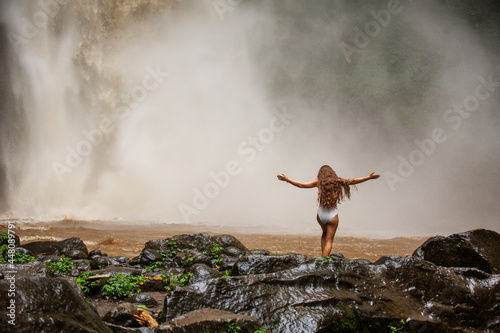 Beautiful woman near a waterfall in Bali