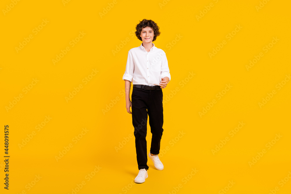 Full body photo of nice little brunet boy go wear white shirt trousers shoes isolated on yellow background Full body photo of nice little brunet boy go wear white shirt trousers shoes isolated on yellow background