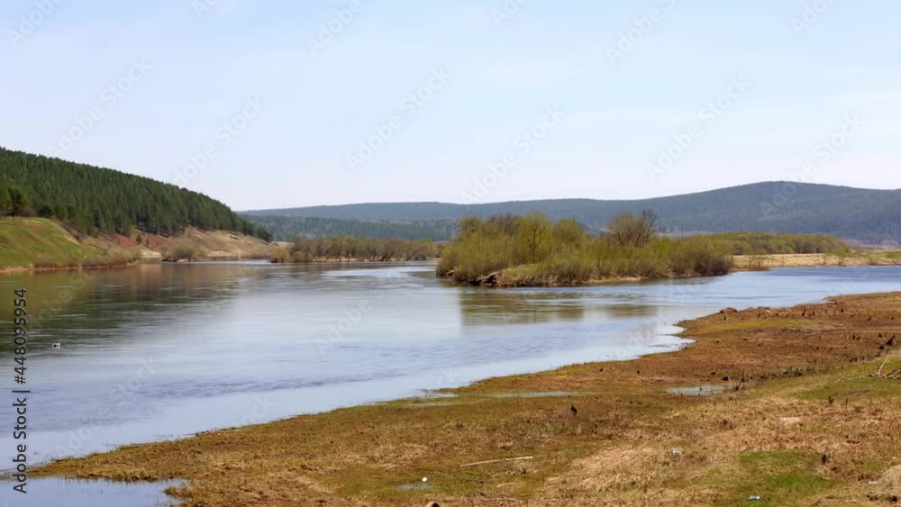 Panoramic view of the middle-size river surrounded by mountains and forest in northern Siberia. Panoramic view of the middle-size river surrounded by mountains and forest in northern Siberia.