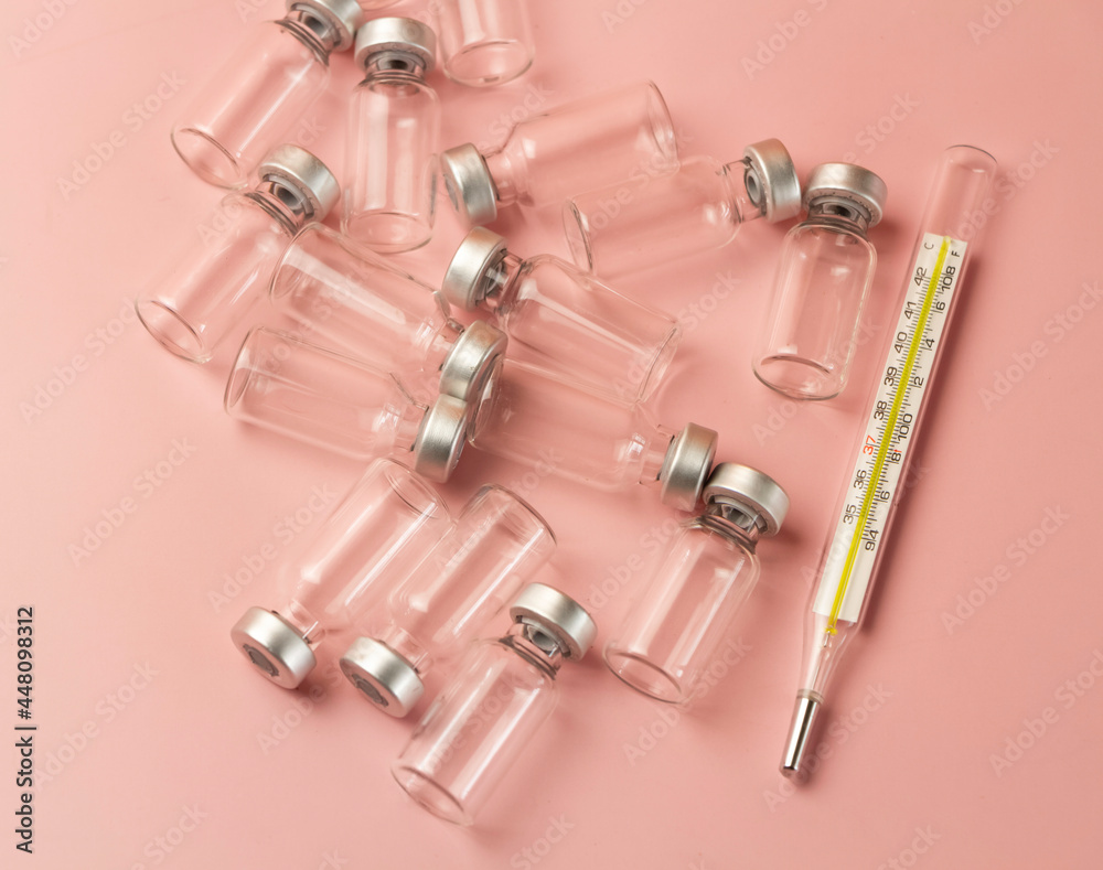Vaccine glass bottle and clinical thermometer Vaccine glass bottle and clinical thermometer