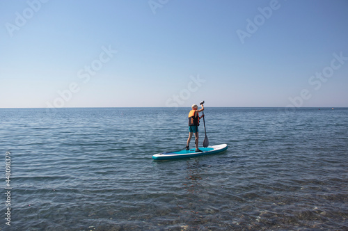 boy sailing on Sup board on the sea