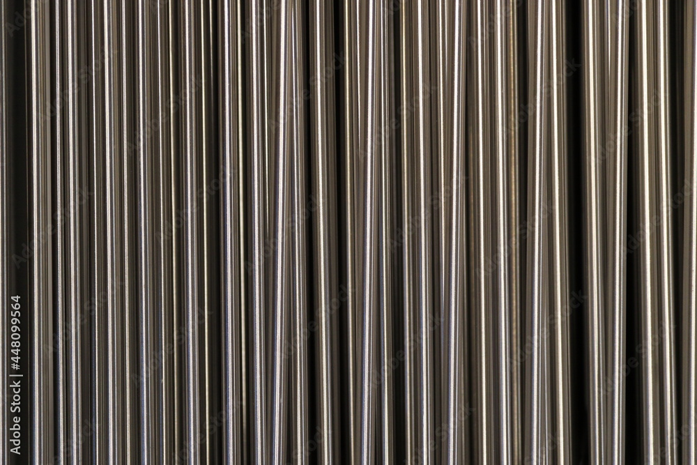 Obraz premium Shiny metal rods arranged in a row.