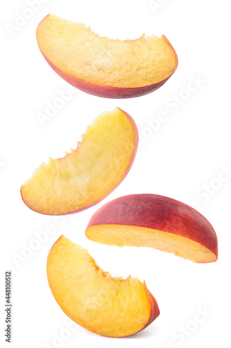 Peach slices falling on a white background, levitating peach. Isolated