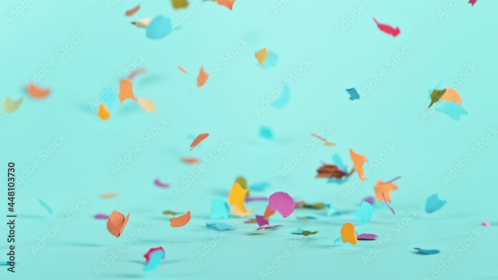 Falling Colorful Confetti on Pastel Blue Background. Super Slow Motion, 1000 FPS. Falling Colorful Confetti on Pastel Blue Background. Super Slow Motion, 1000 FPS.