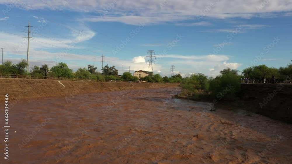 Raging Muddy Waters Of Santa Cruz River After Monsoon Rain In Tucson, Arizona. drone shot Raging Muddy Waters Of Santa Cruz River After Monsoon Rain In Tucson, Arizona. drone shot
