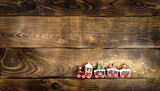 Brown rich wooden background from horizontal planks.Christmas toy train on a brown wooden background. Christmas card, congratulation, holiday package.