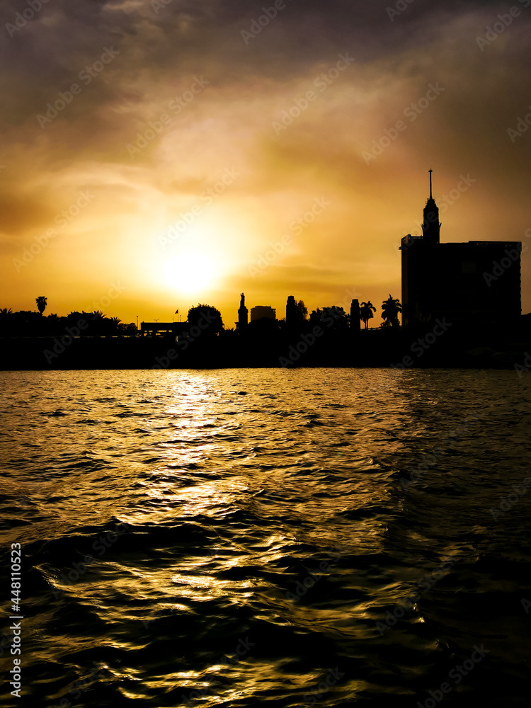Black silhouette of the river and city at sunset. Cairo cityscape at the Nile river at dusk.