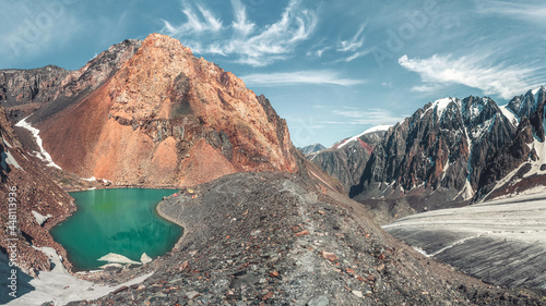 Panoramic view of the base camp on the shore of the high-altitude Blue Lake and the Bolshoy Aktru glacier. Altai Mountains, Russia.