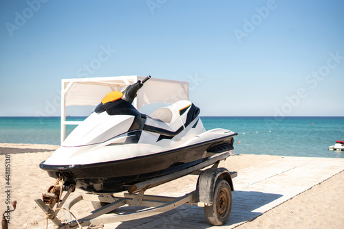 jetski sport water bike on the trailer on the sandy beach on vacation