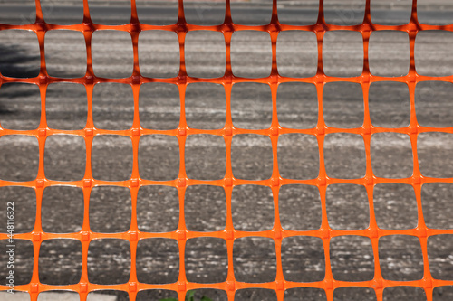 Red fence mesh at the roadbed
