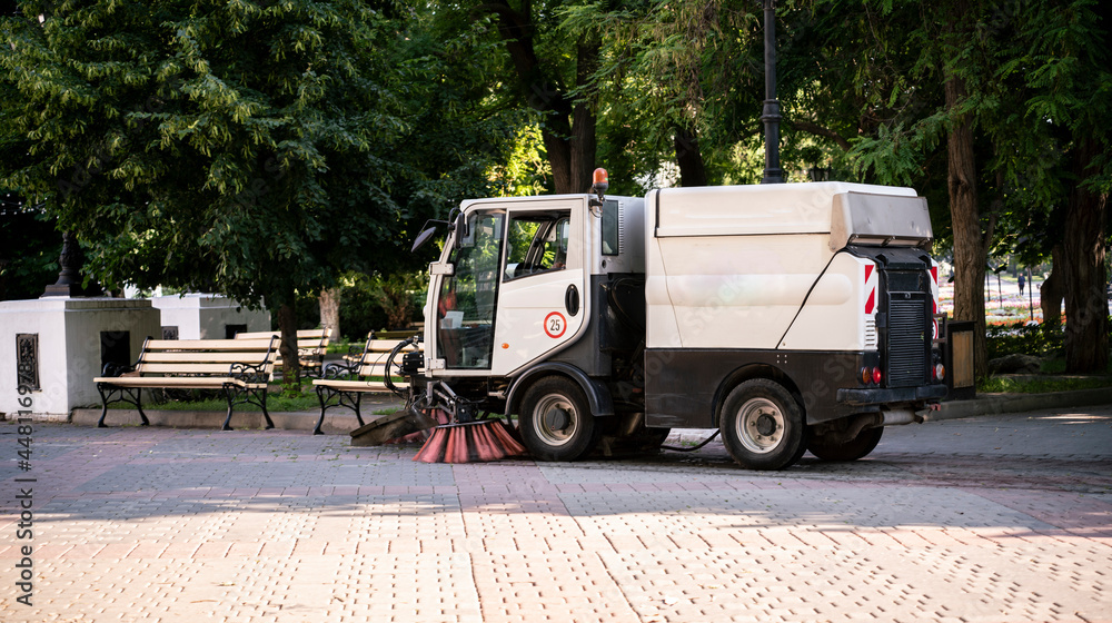 compact small washing machine in the  city street, municipal sweeper