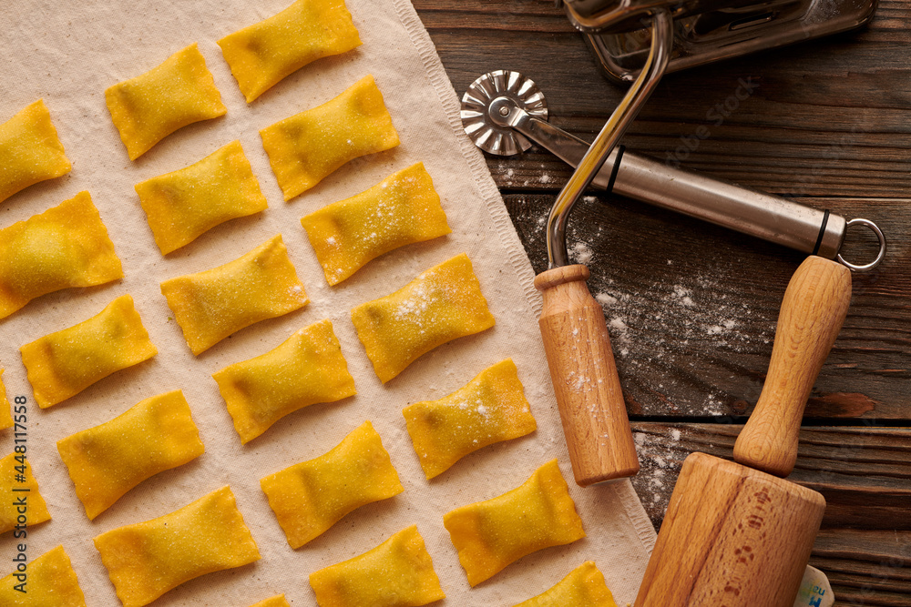 Fototapeta premium Raw homemade ravioli pasta with spinach and ricotta