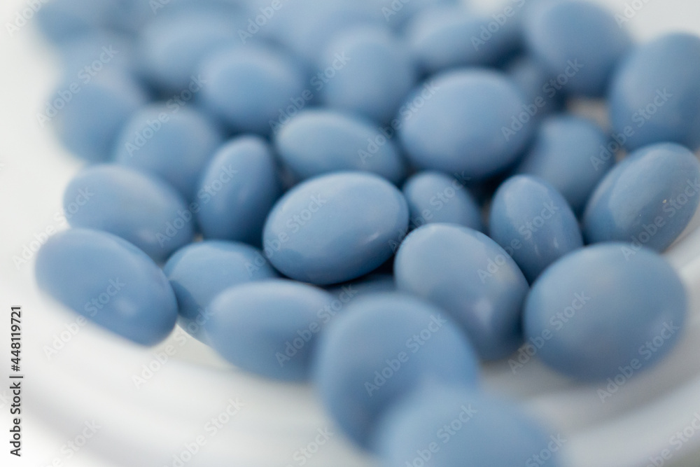 blue medicine pills with bottle on white background