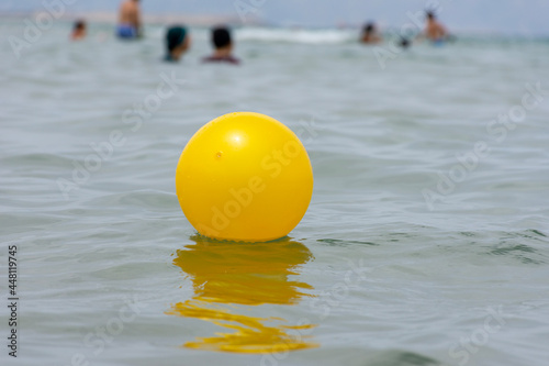 Close up of yellow beach ball floating on the water. © Hamdi Bendali