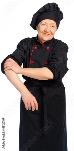 woman chef in black uniform. apron, shirt, hat. elderly woman. The food preparation specialist rolls up his sleeve, ready to go. White background