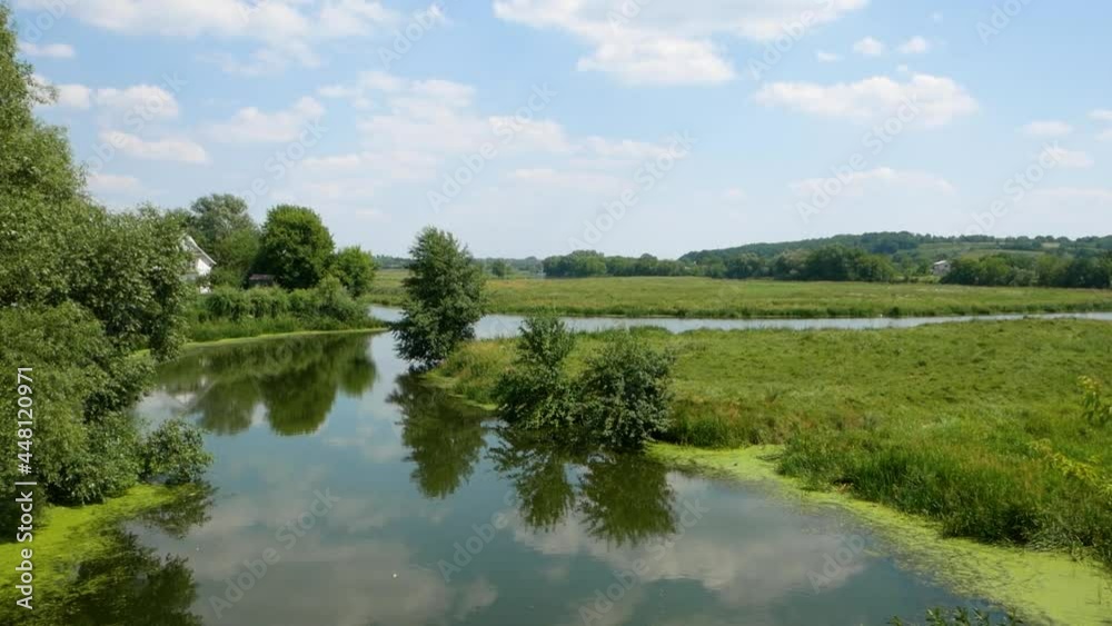 Summer river. River in summer. Green field near the river. Summer river. River in summer. Green field near the river.