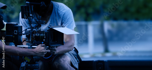 Video production behind the scenes. Making of TV commercial movie that film crew team lightman and cameraman working together with film director in studio. film production concept. Silhouette style. photo