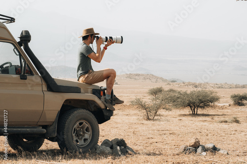 Traveling photographer taking photos during safari photo