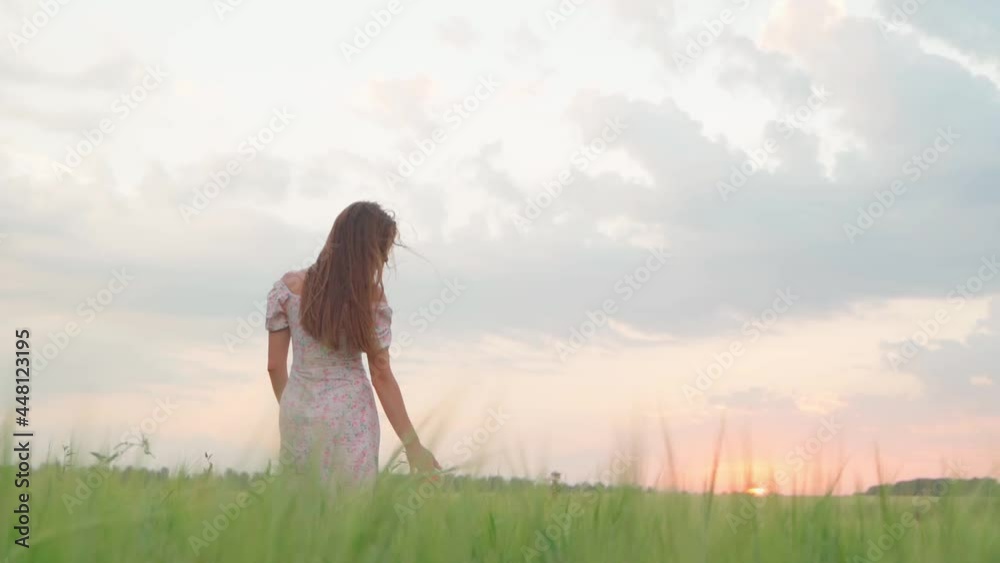 Girl in a white dress in a wheat field at sunset Girl in a white dress in a wheat field at sunset