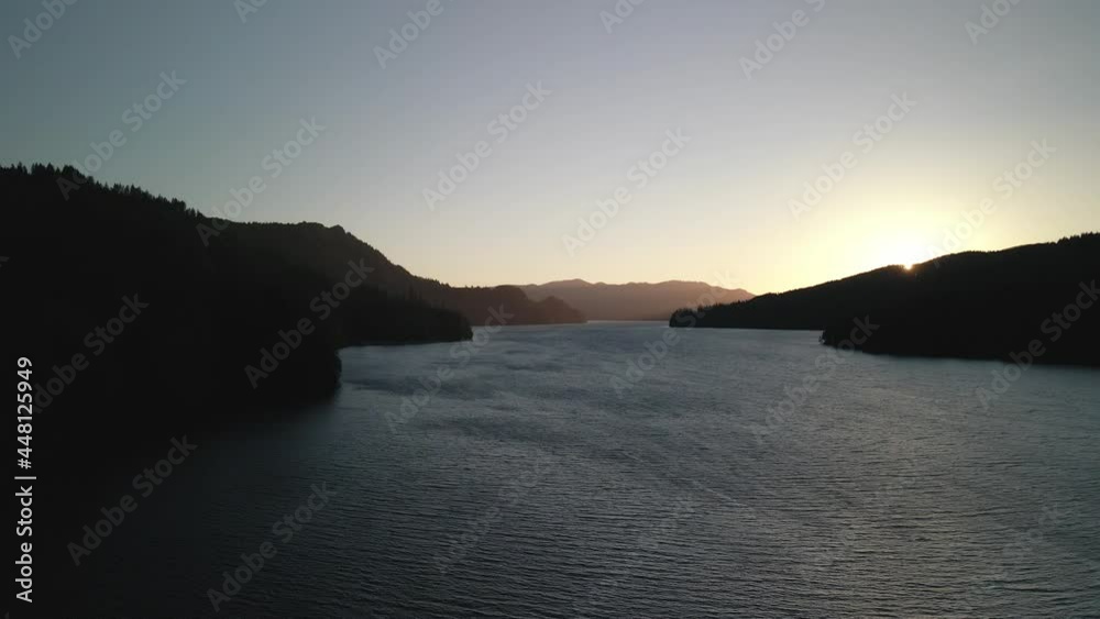 Bird's-eye view of the sunrise over the river with hilly terrain. High quality 4k footage Bird's-eye view of the sunrise over the river with hilly terrain. High quality 4k footage