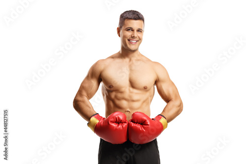 Shirtless boxer with red gloves smiling at camera © Ljupco Smokovski