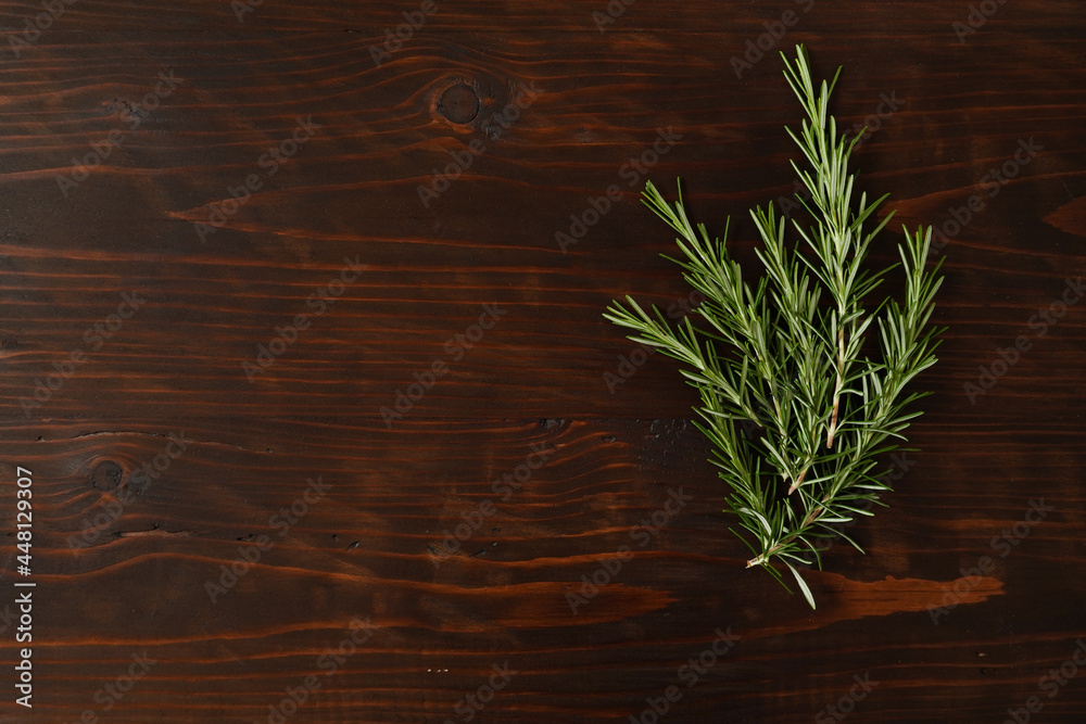 Fresh rosemary bound on brown wooden board. Healthy organic concept. Aroma herb for cooking Fresh rosemary bound on brown wooden board. Healthy organic concept. Aroma herb for cooking