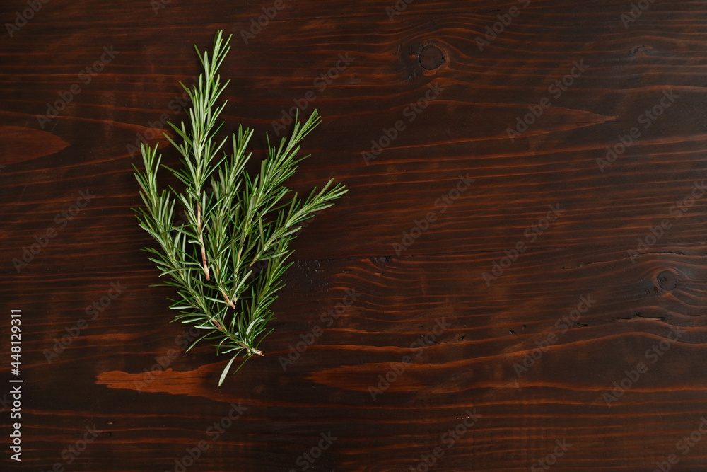 Fresh rosemary bound on brown wooden board. Healthy organic concept. Aroma herb for cooking Fresh rosemary bound on brown wooden board. Healthy organic concept. Aroma herb for cooking