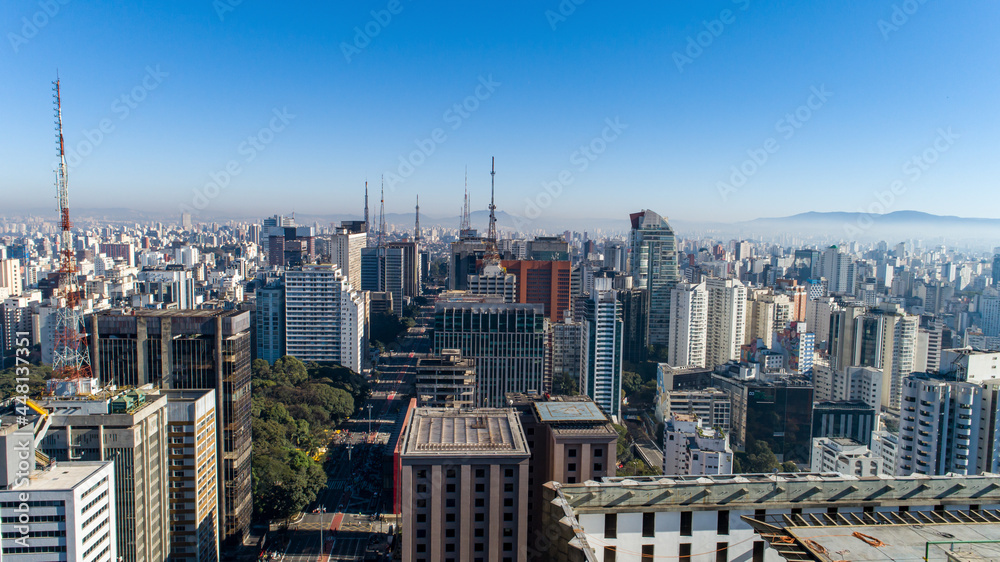 Fototapeta premium Aerial view of Av. Paulista in São Paulo, SP. Main avenue of the capital. Sunday day, without cars, with people walking on the street