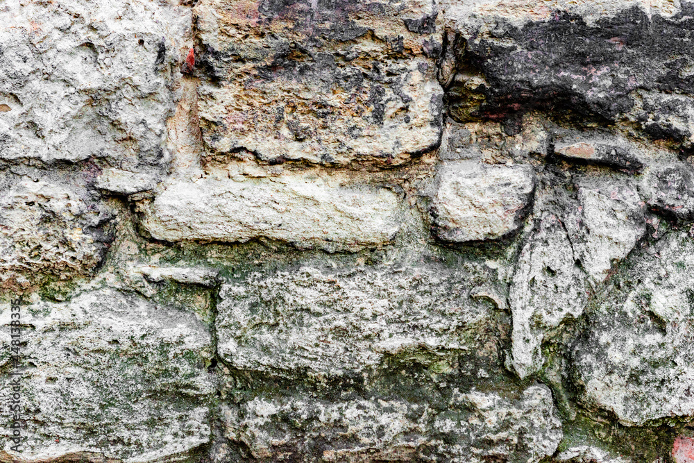 Obraz premium Texture of a brick wall with cracks and scratches which can be used as a background