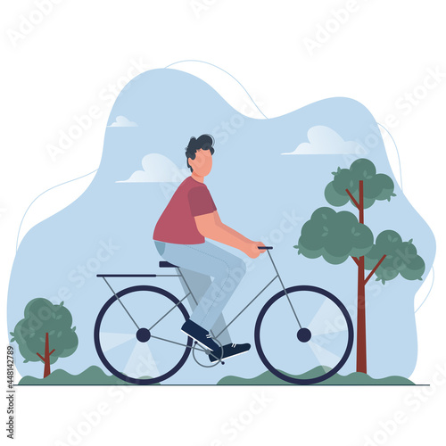 Young man riding bicycle among trees. Cycling boy practicing active eco life on bike in public city park. Outdoor sport activity.