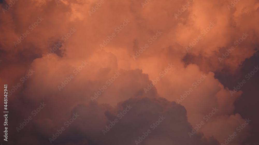 Masses of clouds hanging in the sky in red and white and crimson hues