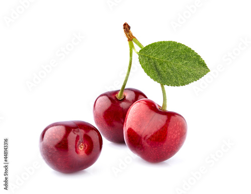 Sweet cherries isolated on white background cutout. Ripe berries with leaf closeup.