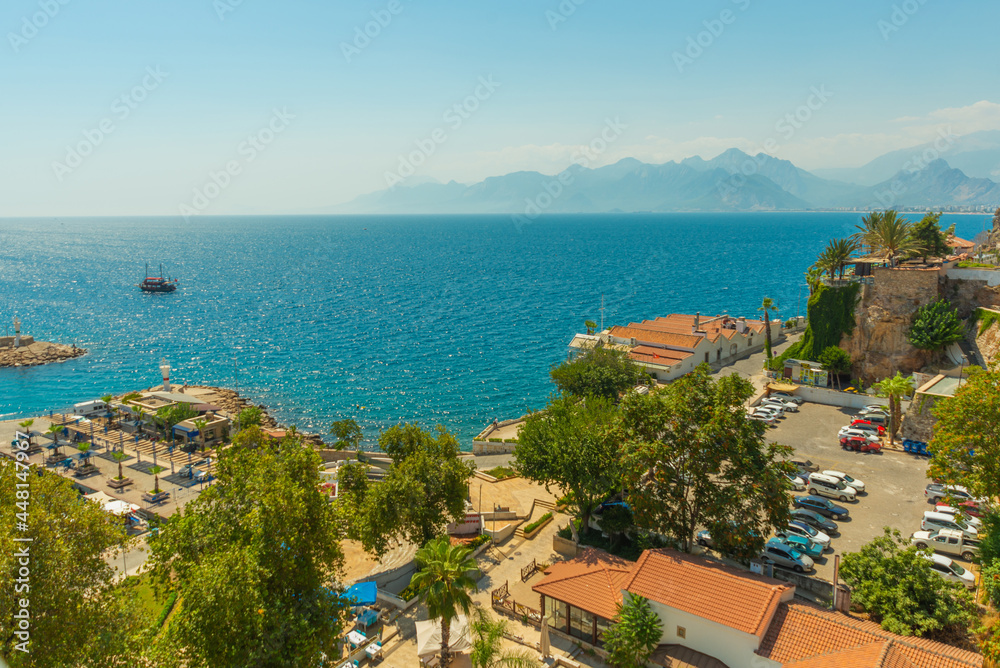 ANTALYA, TURKEY: Top view of the old town, the sea and the mountains on a sunny summer day in Antalya.