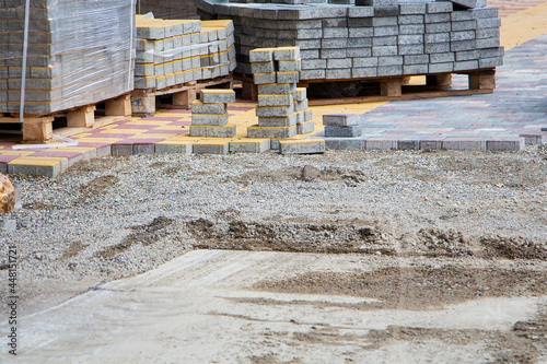 Process of construction of brick paved sidewalk, half built pavement road