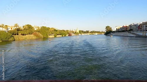 Time lapse sailing along the river Guadalquivir in Seville, Spain photo