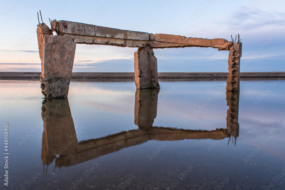 The reflection of the remains of an abandoned house in the river, the reflection of the concrete pillars of an old house in the lake, the beautiful architectural shapes; jijel Algeria The reflection of the remains of an abandoned house in the river, the reflection of the concrete pillars of an old house in the lake, the beautiful architectural shapes; jijel Algeria