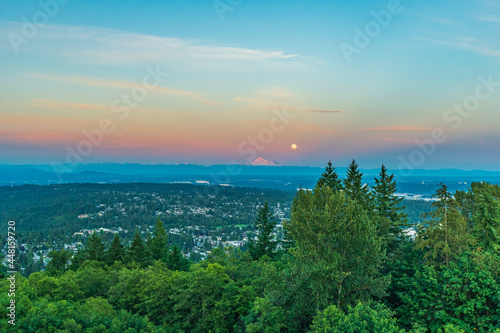 Simultaneous sunset and moonrise over Mount Baker as seen across Fraser Valley from Burnaby Mountain