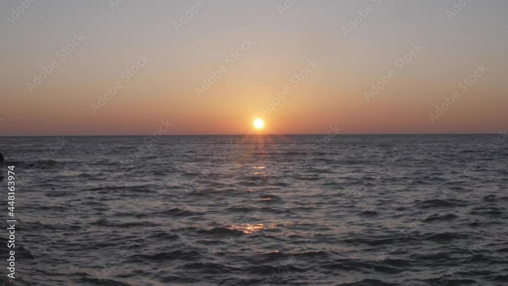 View of the sunset on the horizon of the high wave pacific ocean. View of the sunset on the horizon of the high wave pacific ocean.