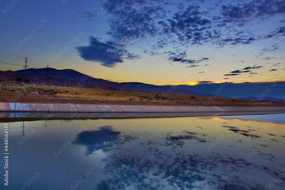 Fototapeta premium Sunset at The California Aqueduct With Mountain Background