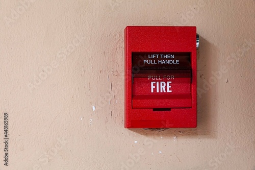 Fire alarm switch on the cement wall © torsakarin